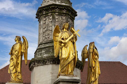 Zagreb, Croatia - September 23, 2023: Virgin Mary with angels column in front of gothic Zagreb Cathedral, Roman Catholic church located at Kaptol (Upper Town)