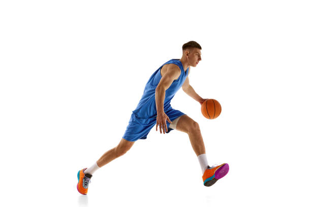 istock Young man, athlete in motion, basketball player during game, practicing isolated over white background. Sport concept 1909076737