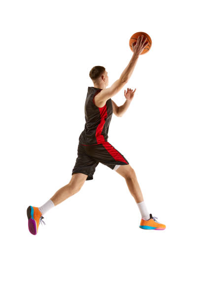 istock Young competitive guy, basketball player in uniform playing, training isolated over white background. Full-length. Sport concept 1909077256