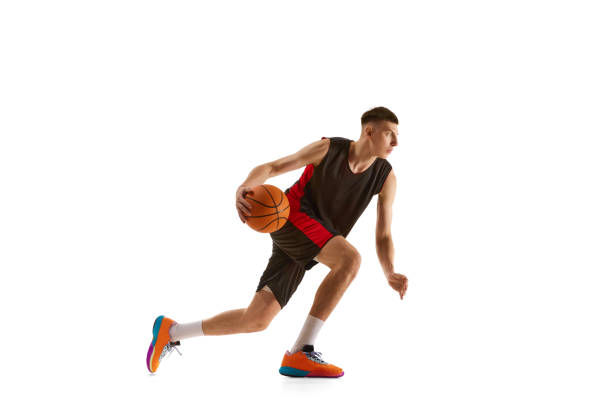 istock Young man, athlete in motion, basketball player during game, practicing isolated over white background. Sport concept 1909077260