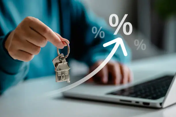 Photo of women holding key houses, Interest rate financial loans and mortgage rates concept. percentage symbol and arrow pointing up. company business growth and sales, compound interest rate, tax, real estate