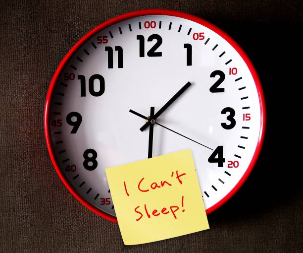 istock Clock on wallpaper point to after midnight with handwritten note I CAN'T SLEEP, concept of insomnia or sleep deprived, when one have trouble sleeping or struggle to fall asleep at night 1909114901