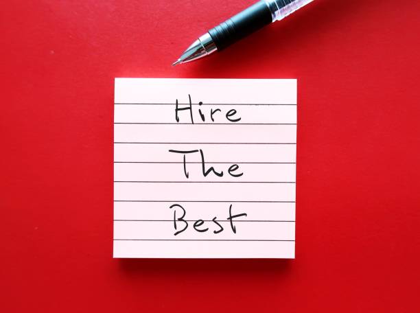 istock Pen on red background writing on note pad HIRE THE BEST, means business owner needs to hire the top talent in their field for future success 1909130942
