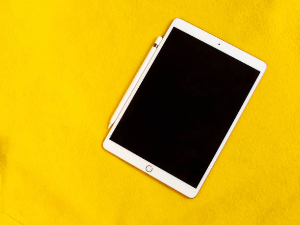 tablet for working and drawing, with a stylus, on a yellow background