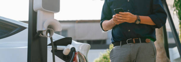 istock Young man use smartphone to pay for electricity for EV car. Expedient 1909159084