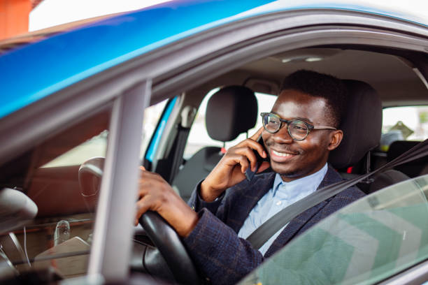 istock Transportation and vehicle concept - man using phone while driving the car. 1909161241