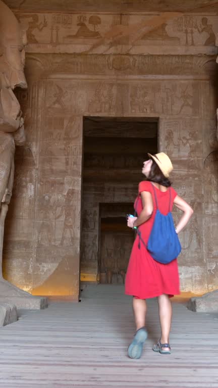 A young tourist visiting the sculptures inside the temple of Abu Simbel, in southern Egypt in Nubia next to Lake Nasser. Temple of Pharaoh Ramss II, 4k video