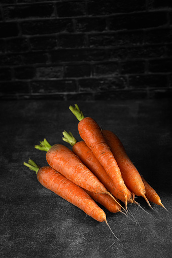 fresh carrots on black back
