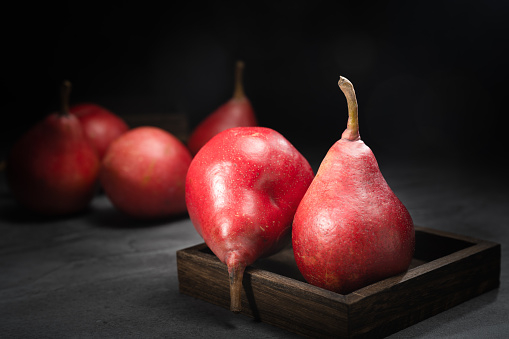 Red pear on wooden background