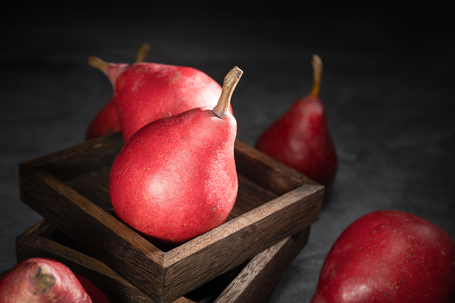 Red pear on wooden background