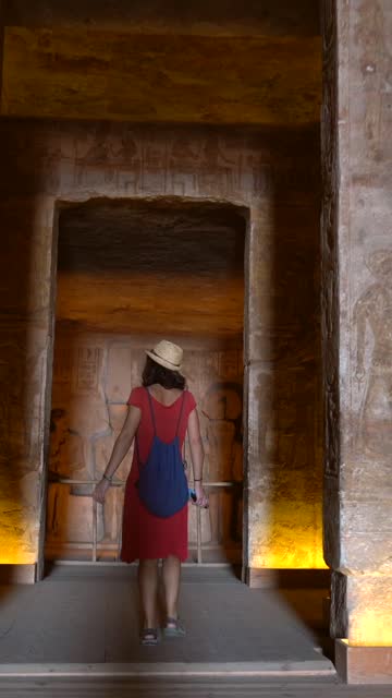 A young tourist visiting the sculptures inside the temple of Abu Simbel, in southern Egypt in Nubia next to Lake Nasser. Temple of Pharaoh Ramss II, 4k video