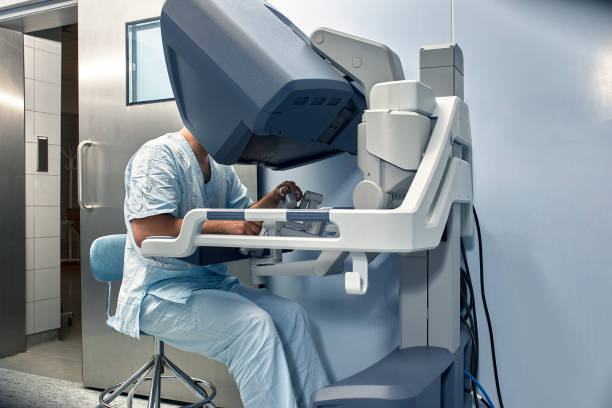 istock The surgeon is at the computer robot in a special control module, the medical robot is under the control of the doctor at a distance through the monipulator. Robotic surgery without incision, minimally invasive removal of a malignant tumor 1909184823