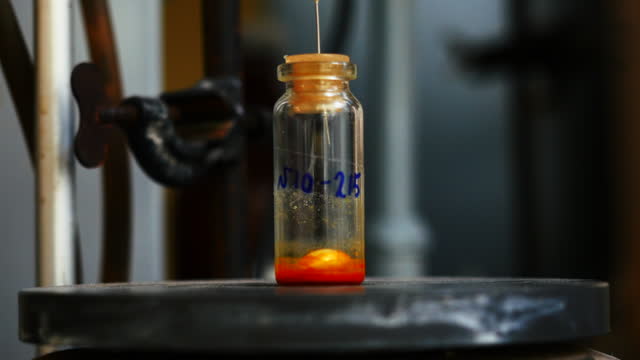 Laboratory test tube with rotating particle and liquid. Stock footage. Rotating liquid in test tube in chemical laboratory. Chemical compound in small test tube.