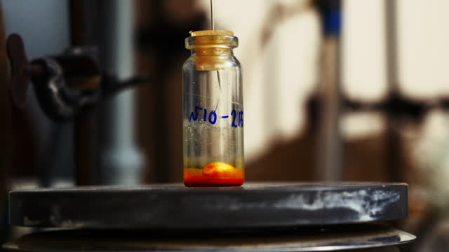 Laboratory test tube with rotating particle and liquid. Stock footage. Rotating liquid in test tube in chemical laboratory. Chemical compound in small test tube.