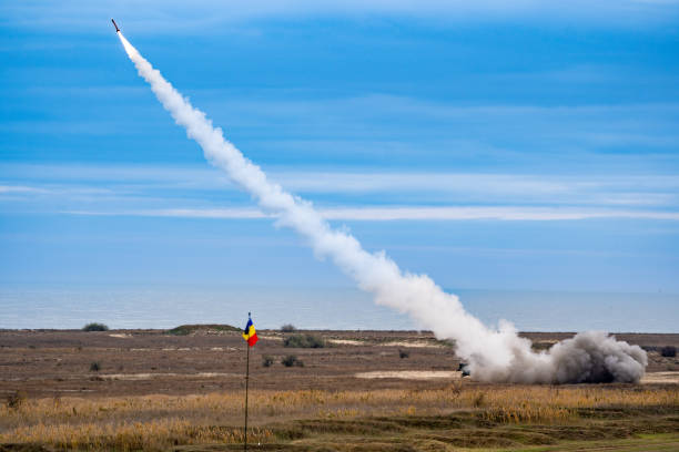 istock Rocket soaring in the sky, with a billowing cloud of smoke trailing behind it 1909202224
