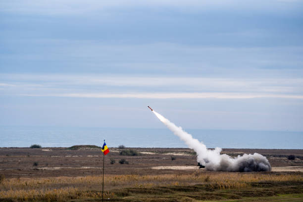 istock Rocket soaring in the sky, with a billowing cloud of smoke trailing behind it 1909202238