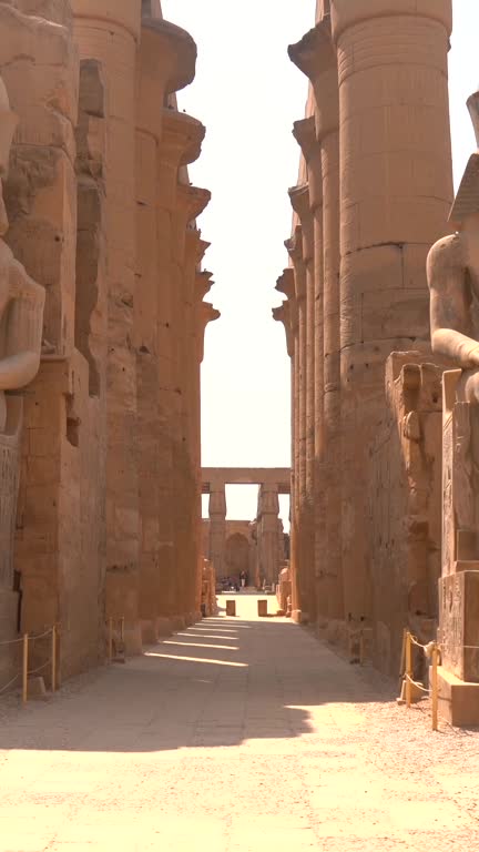 Sculptures of pharaohs inside the Luxor Temple and the drawings Egyptian columns