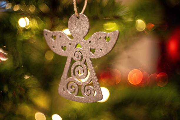istock a small angel ornament hangs from the christmas tree 1909218962