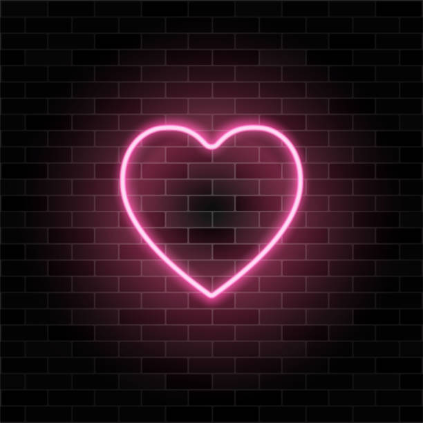 istock Glowing neon heart on black brick wall background. Retro pink neon heart sign. Design element for valentine's day. Night light advertising. 1909218985