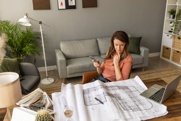 istock Young female entrepreneur using smart phone at modern working place. 1909231409