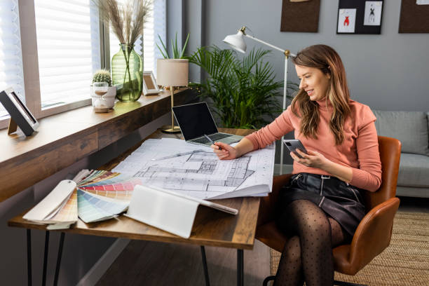 istock Female designer in office working on architects project. 1909231413