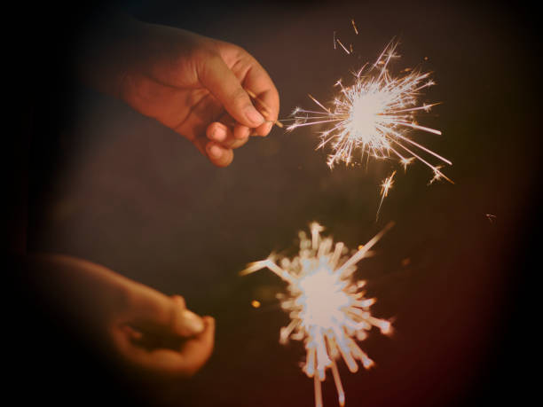 istock Holding a sparkler for special day . BLUR BACKGROUND 1909232451
