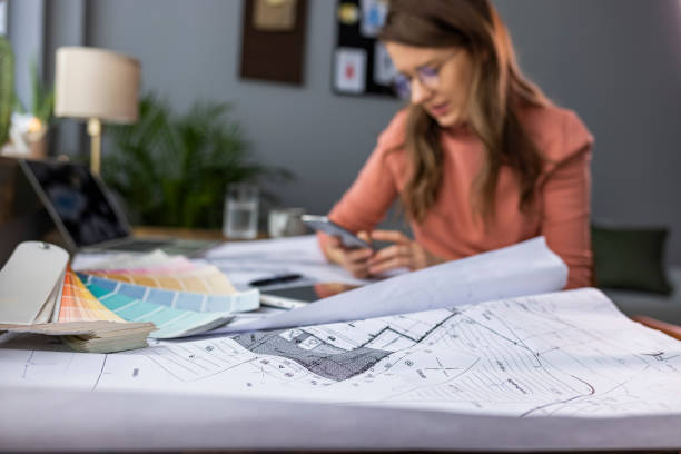 istock Young female entrepreneur using smart phone at modern working place. 1909232992
