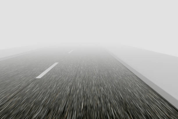 Driving a car on an asphalt road during fog.