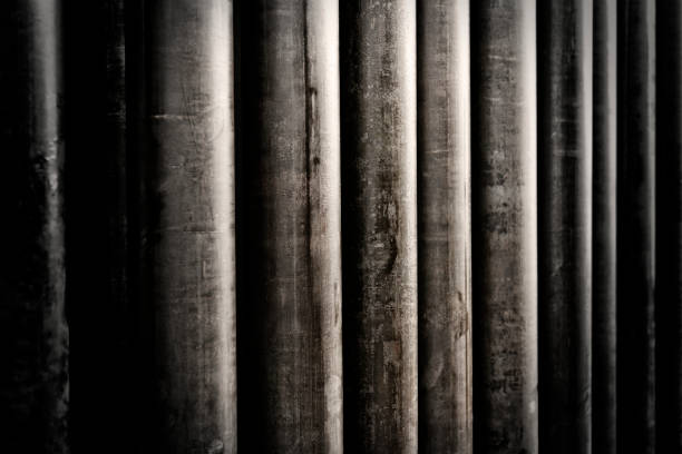 Pile of industrial steel drilling pipes, organized neatly in a stack A pile of industrial steel drilling pipes, organized neatly in a stack linker stock pictures, royalty-free photos & images