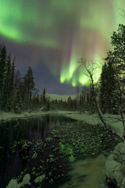 istock Northern lights above the frozen river, Lapland 1909265914