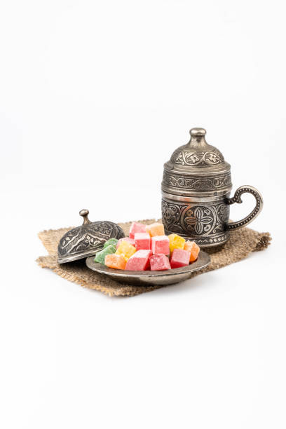 istock Turkish Coffee with Turkish Delight on authentic metal plate, isolated on white background 1909270780