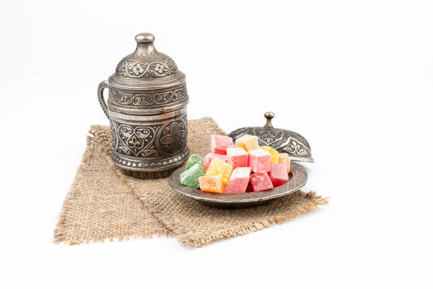istock Turkish Coffee with Turkish Delight on authentic metal plate, isolated on white background 1909270789