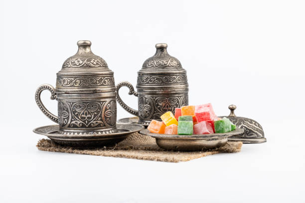 istock Turkish Coffee with Turkish Delight on authentic metal plate, isolated on white background 1909271300