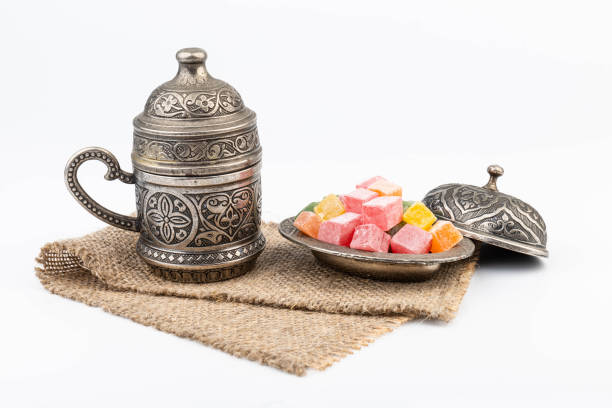 istock Turkish Coffee with Turkish Delight on authentic metal plate, isolated on white background 1909271843