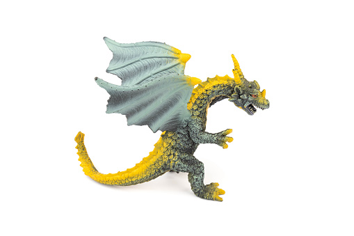 Beautiful and cool green and yellow dragon toy, isolated on white background