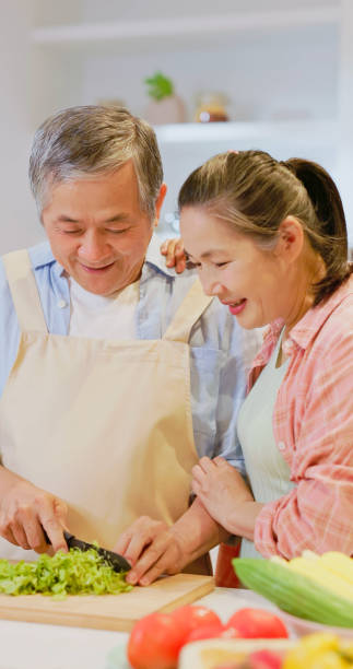 istock Asian elderly couple in kitchen 1909284486