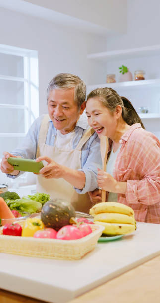 istock Asian elderly couple in kitchen 1909286056