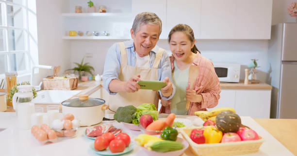 istock Asian elderly couple in kitchen 1909286266