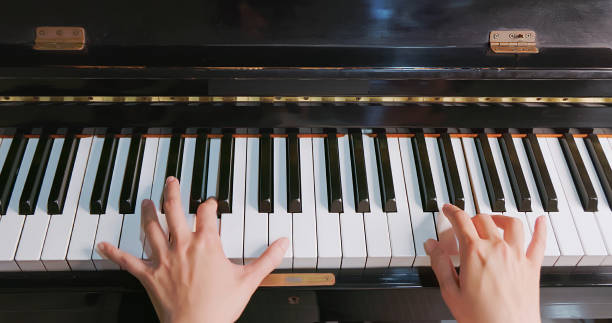 istock hands of asian play piano 1909289560