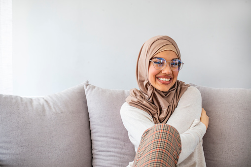 Young muslim woman in head scarf smile. Beautiful middle eastern woman wearing abaya. Arabian woman with happy smile. Strict formal outfit and elegant appearance. Islamic fashion.