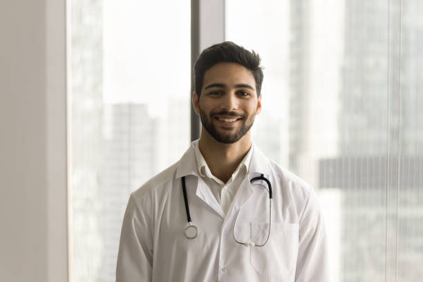 istock Happy handsome young Arab doctor man posing for shooting 1909307195