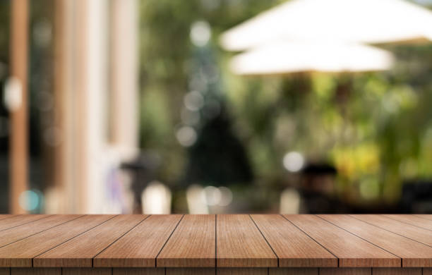 istock Empty wooden table top with lights bokeh on blur restaurant background. 1909314588