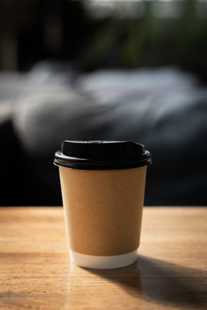 istock Take away cup of coffee on wooden table. 1909316172