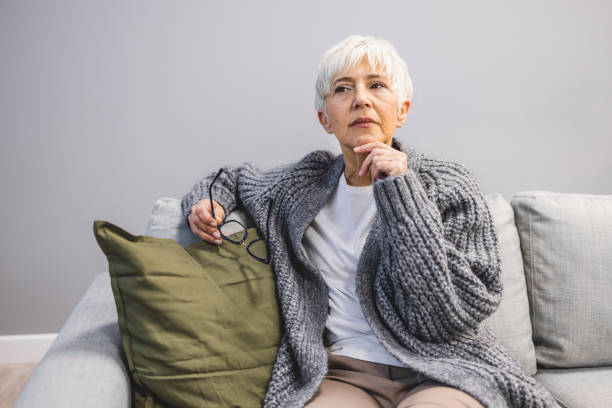 istock Head shot unhappy mature woman lost in thoughts 1909323982