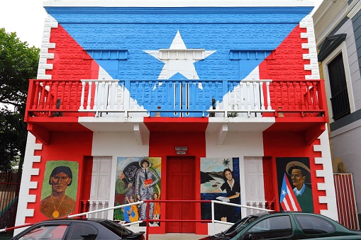 San Juan, United States – November 10, 2016: An old building in US flag colors in Puerto Rico, USA