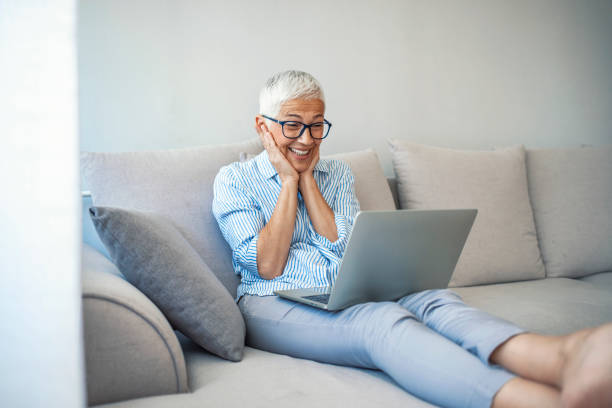 istock Senior woman making video call on laptop 1909343802