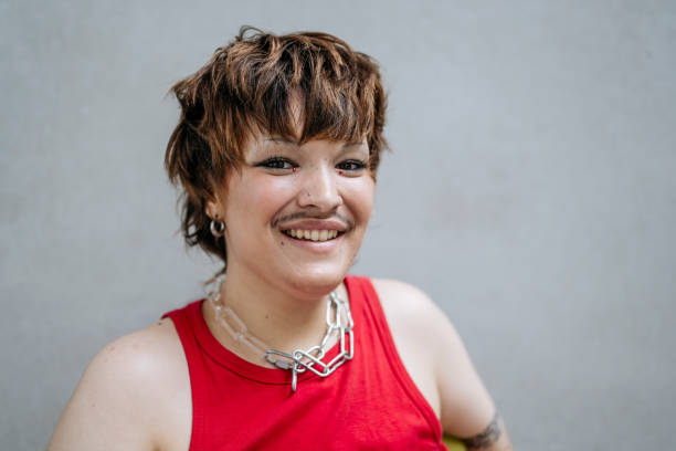 Relaxed and cheerful transgender man in early 20s