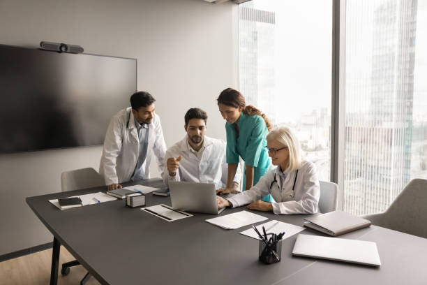 istock Team of medical colleagues using laptop for Internet communication 1909366832