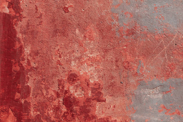 istock Red concrete wall with deep scratches and chips. Various variations of abrasions. 1909371044