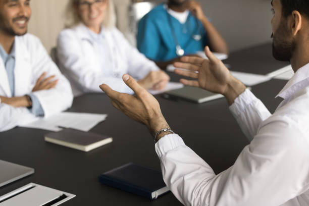 istock Young male doctor talking to diverse team 1909376743